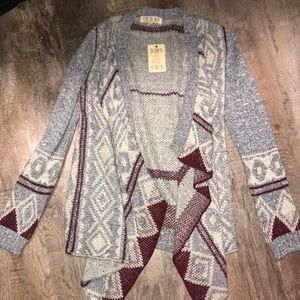 A pink rose cardigan that was bought at Vonmaur